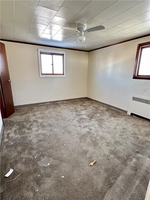 unfurnished room with carpet flooring and radiator heating unit