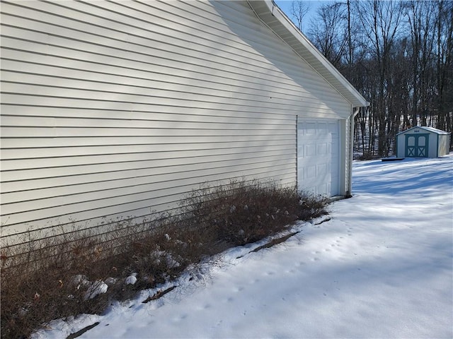 view of snow covered exterior featuring a storage shed