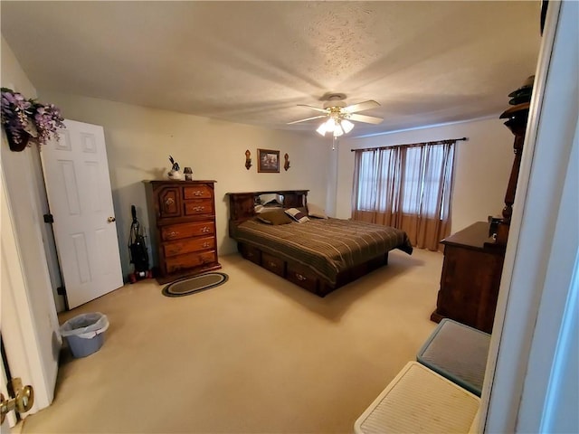 carpeted bedroom with ceiling fan and a textured ceiling