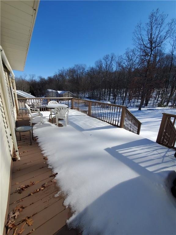 yard layered in snow featuring a wooden deck