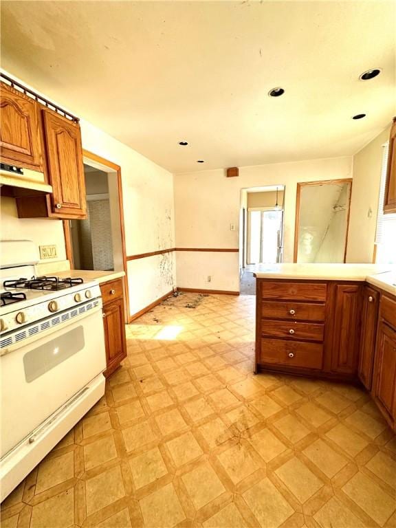 kitchen with white range with gas stovetop