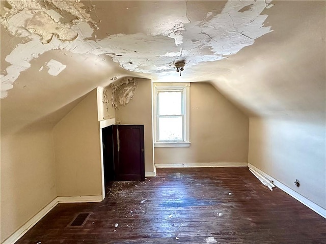 bonus room with dark hardwood / wood-style flooring and lofted ceiling