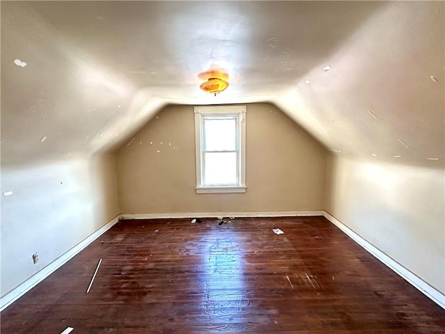 bonus room featuring dark hardwood / wood-style floors and vaulted ceiling