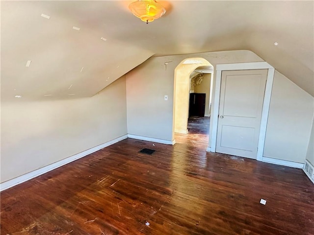 additional living space with lofted ceiling and dark wood-type flooring