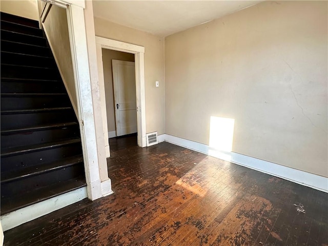 empty room with dark hardwood / wood-style floors