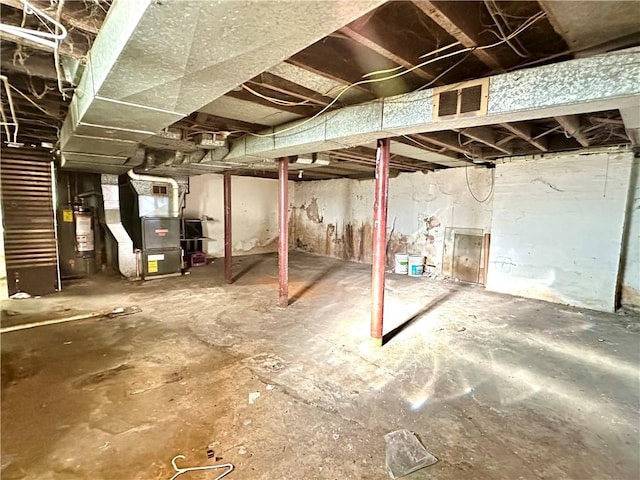 basement featuring heating unit and water heater