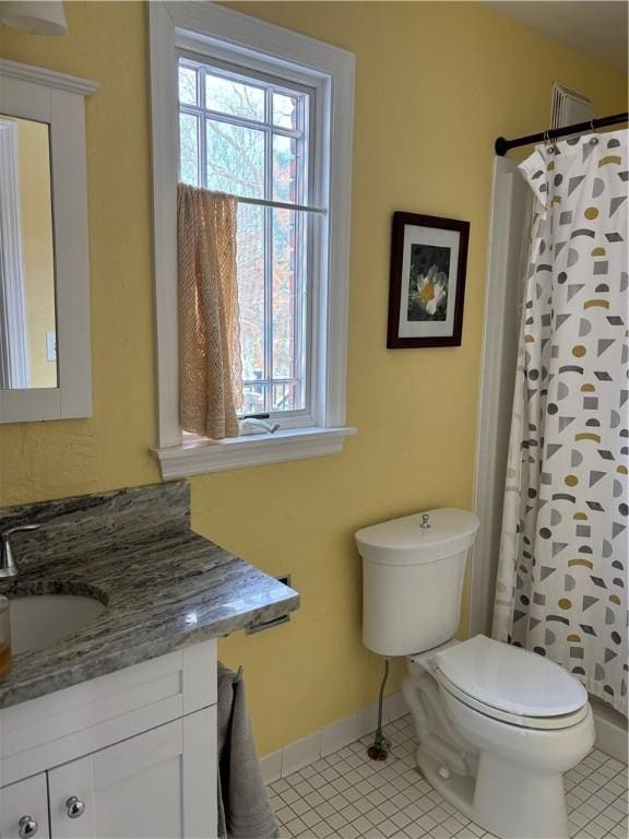 bathroom with curtained shower, toilet, vanity, and tile patterned floors