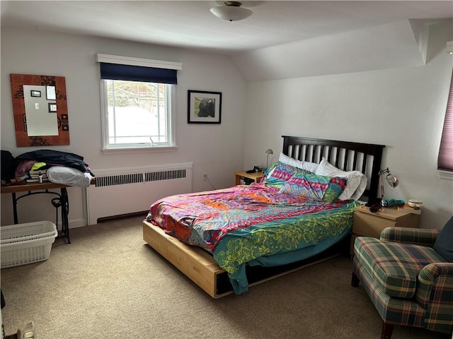 bedroom featuring carpet flooring, radiator heating unit, and vaulted ceiling