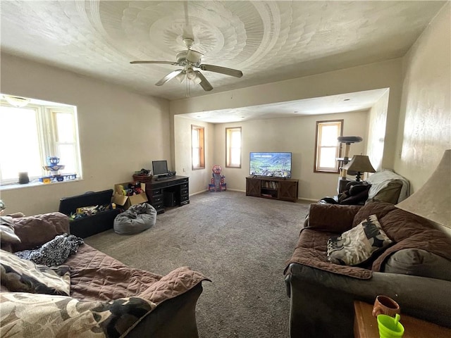 living room featuring carpet flooring, a textured ceiling, and ceiling fan