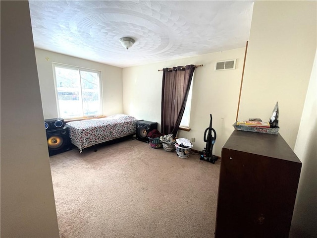 carpeted bedroom featuring a textured ceiling