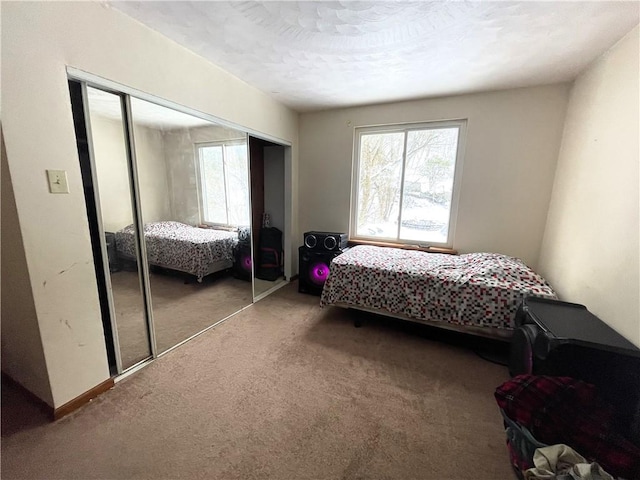 carpeted bedroom featuring a closet