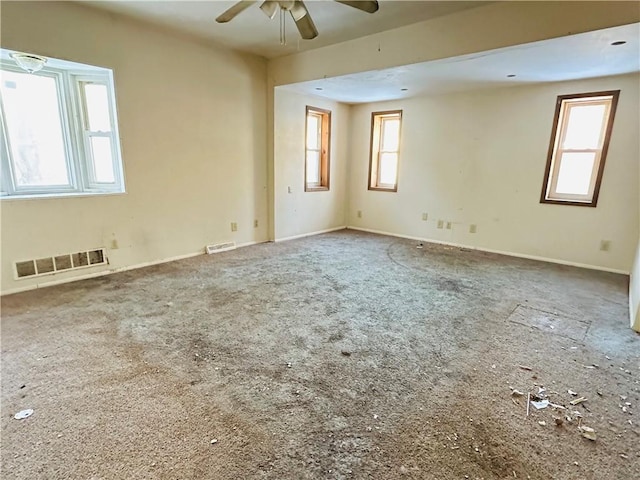 unfurnished room featuring ceiling fan and a healthy amount of sunlight