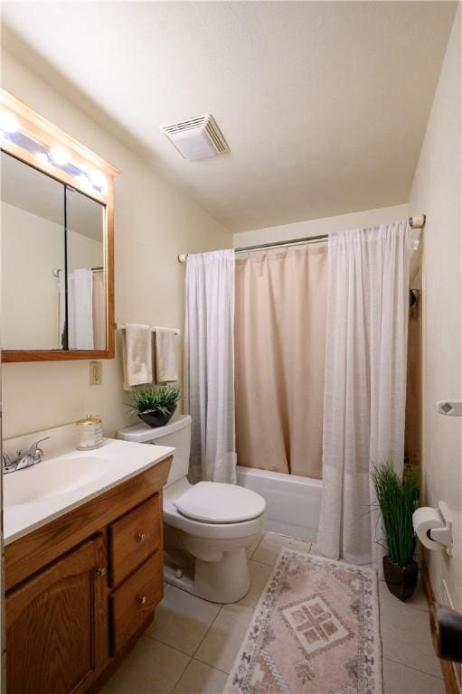 full bathroom featuring tile patterned flooring, vanity, toilet, and shower / bath combo with shower curtain