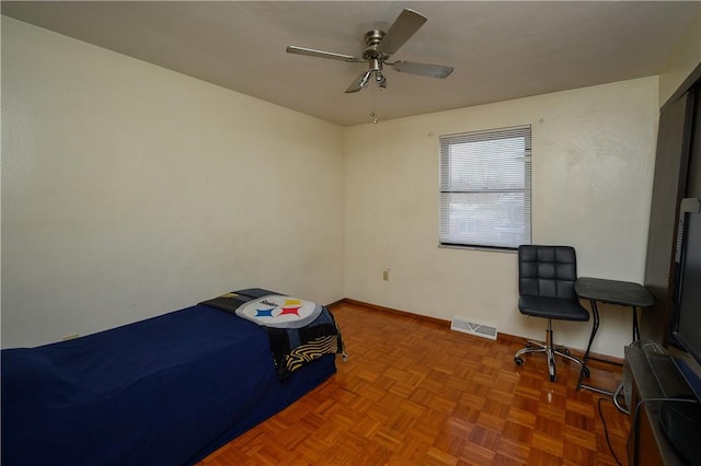 bedroom featuring ceiling fan and parquet floors