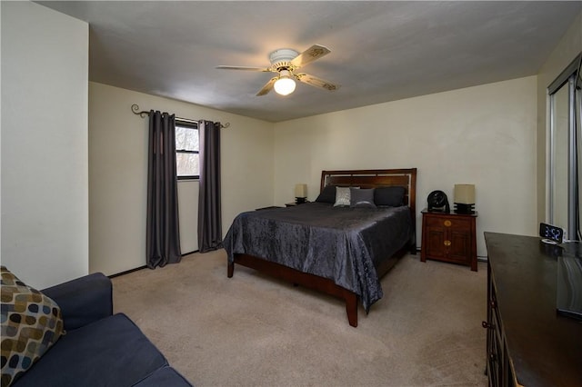 bedroom featuring ceiling fan and light colored carpet