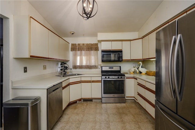 kitchen with stainless steel appliances, sink, decorative light fixtures, white cabinets, and a chandelier