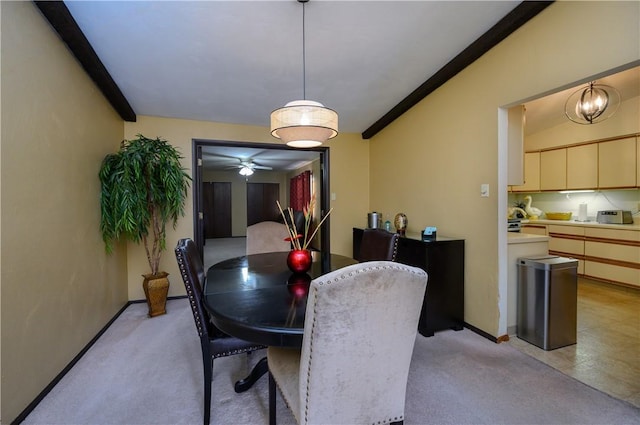 carpeted dining area featuring ceiling fan and ornamental molding