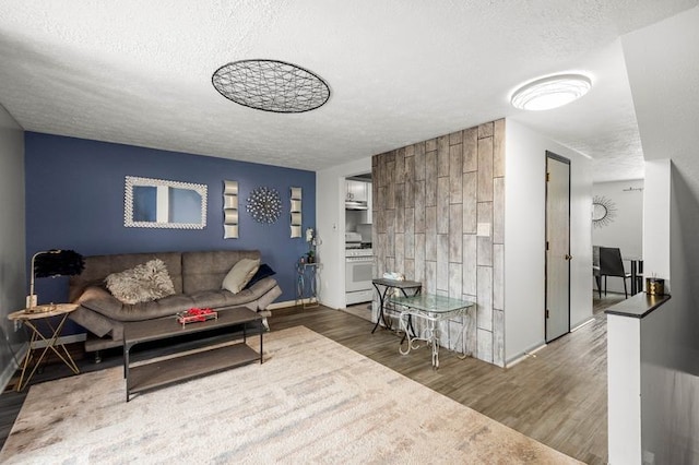 living room with hardwood / wood-style flooring and a textured ceiling