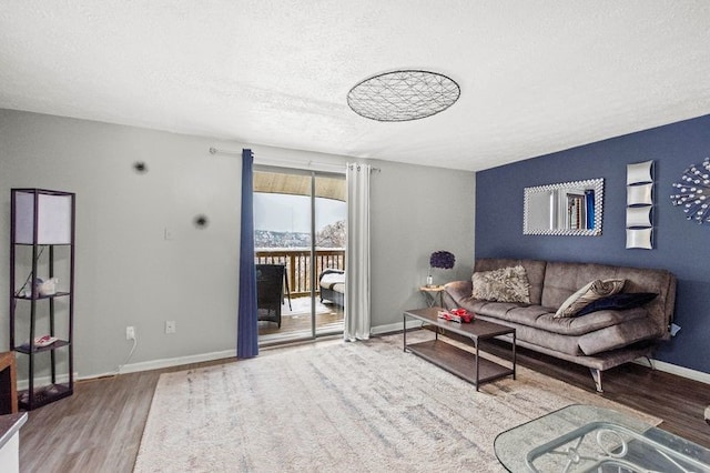 living room featuring a textured ceiling and hardwood / wood-style flooring