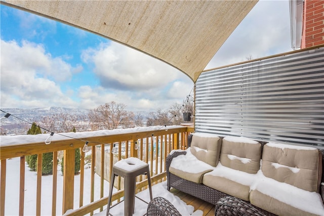 view of snow covered back of property