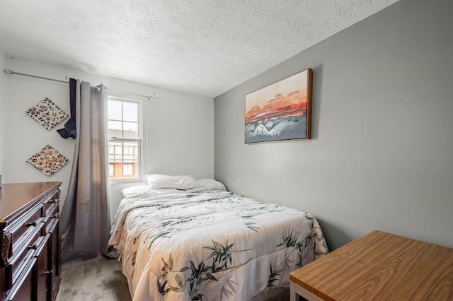 bedroom featuring hardwood / wood-style floors and a textured ceiling