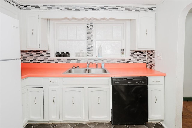 kitchen with sink, black dishwasher, tasteful backsplash, white refrigerator, and white cabinets