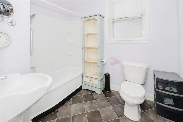 bathroom featuring tile patterned floors, toilet, and sink