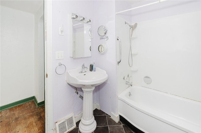 bathroom with tile patterned floors, shower / tub combination, and sink