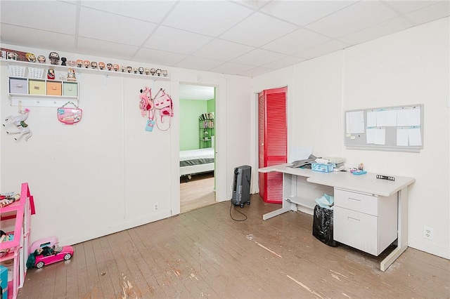 office featuring a paneled ceiling and hardwood / wood-style flooring