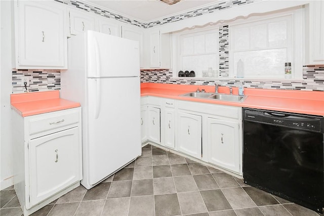 kitchen featuring backsplash, sink, white refrigerator, white cabinets, and black dishwasher