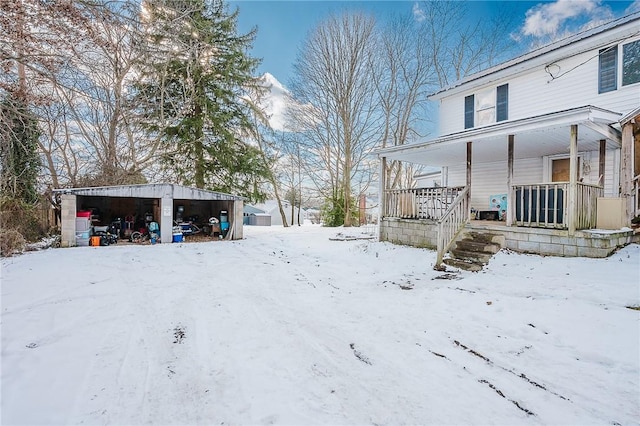 yard covered in snow with covered porch