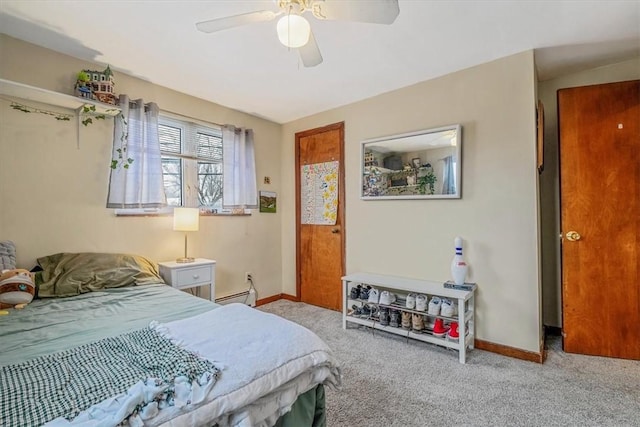 carpeted bedroom with ceiling fan and a baseboard radiator