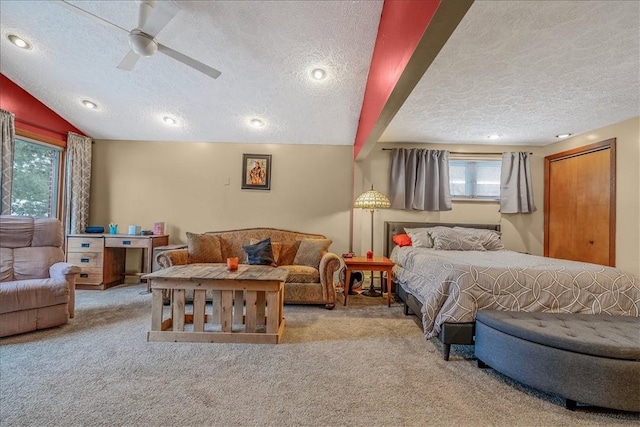 carpeted bedroom with ceiling fan, a textured ceiling, and vaulted ceiling