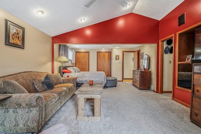 carpeted living room featuring a textured ceiling and vaulted ceiling