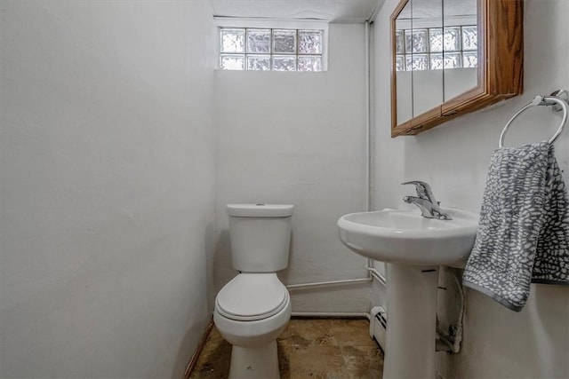 bathroom featuring toilet and a wealth of natural light