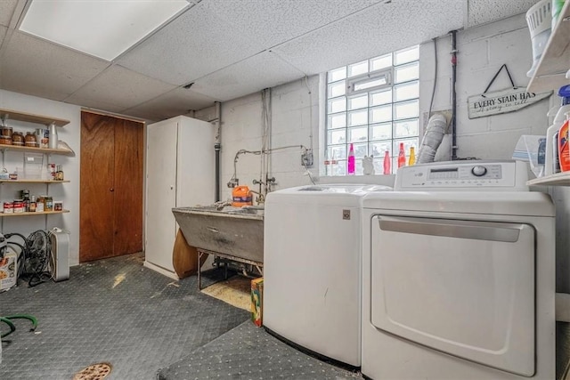 washroom featuring washing machine and dryer and sink