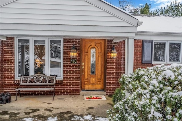 view of snow covered property entrance