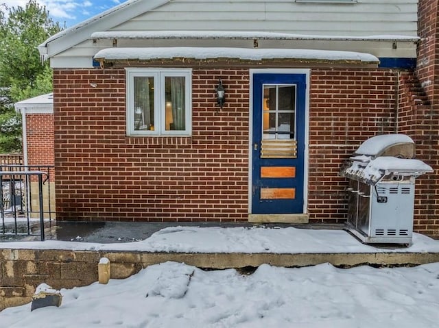 view of snow covered property entrance