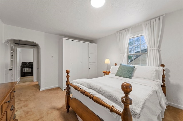 bedroom featuring light carpet and a closet