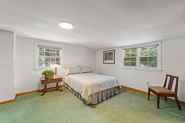 bedroom featuring carpet and vaulted ceiling