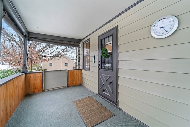 view of exterior entry with covered porch