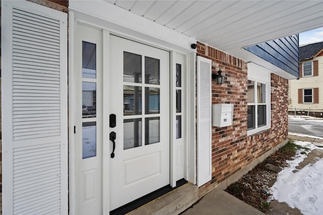 view of snow covered property entrance