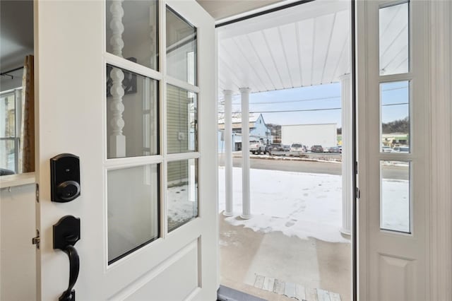 doorway to outside featuring decorative columns