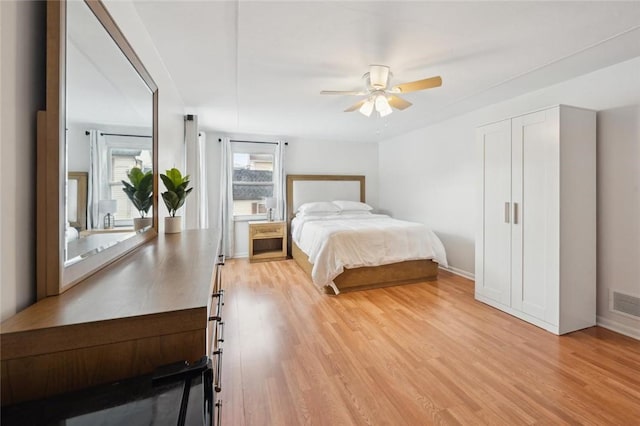 bedroom with ceiling fan and light hardwood / wood-style flooring