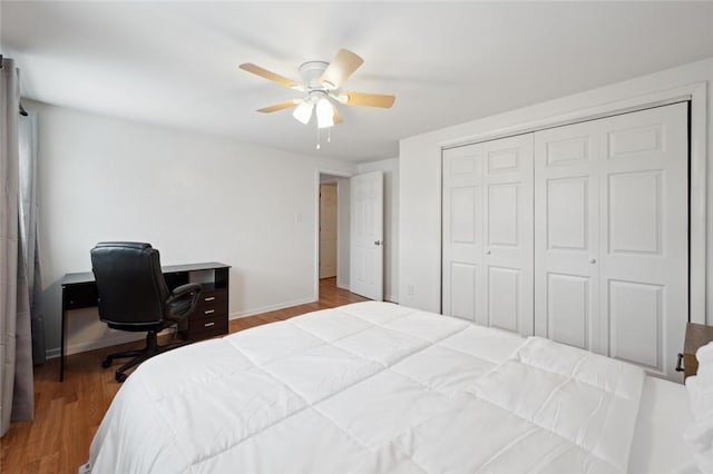 bedroom with a closet, light hardwood / wood-style flooring, and ceiling fan