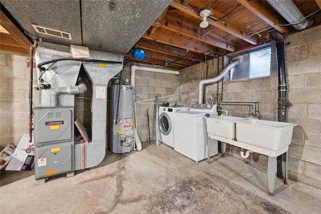 basement featuring washer and dryer and water heater