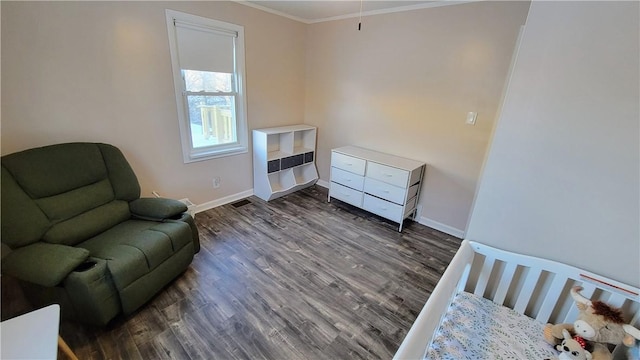 sitting room with crown molding and dark hardwood / wood-style flooring