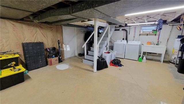 basement with independent washer and dryer, gas water heater, and sink