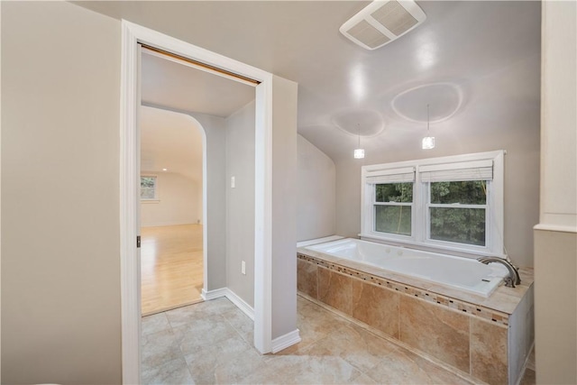 bathroom featuring tiled tub