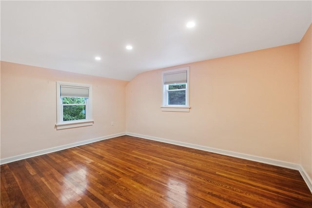 empty room featuring lofted ceiling and dark hardwood / wood-style floors